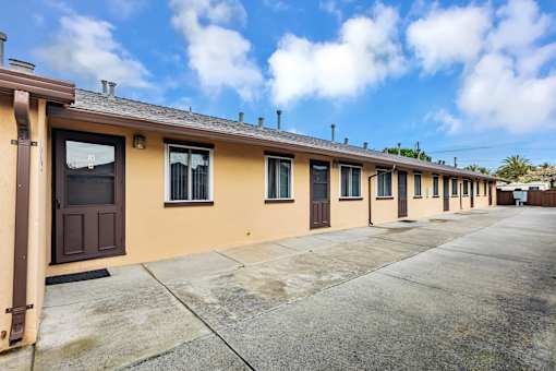 A row of houses with brown doors and windows.