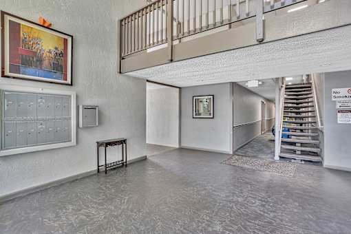 A room with a staircase and a no smoking sign.