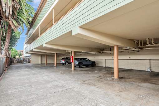 A parking garage with a car parked in the middle.
