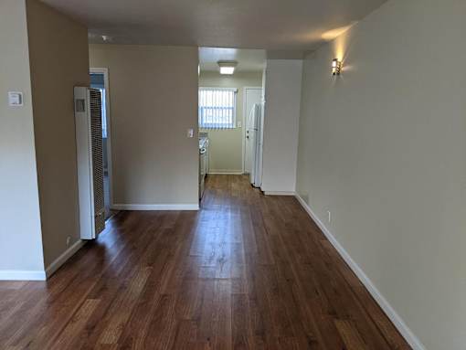 A room with wooden floors and white walls.