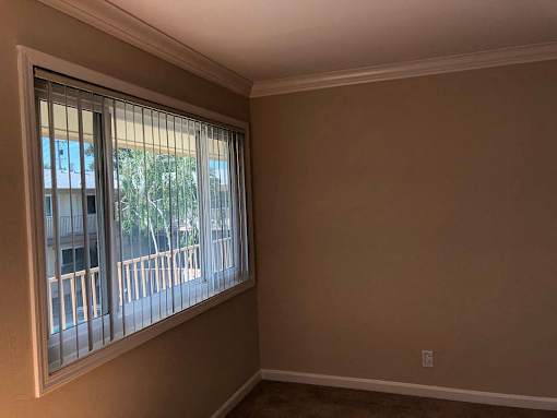 an empty living room with a large window