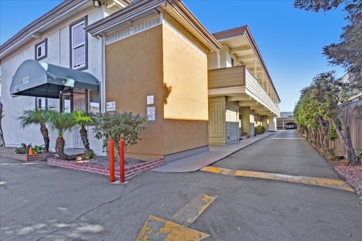 A street view of a building with a green awning and a yellow line on the road.