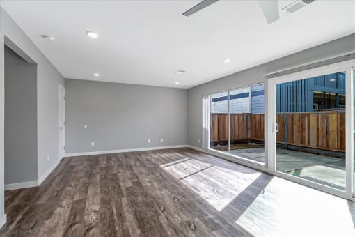 a living room with a sliding glass door to a patio