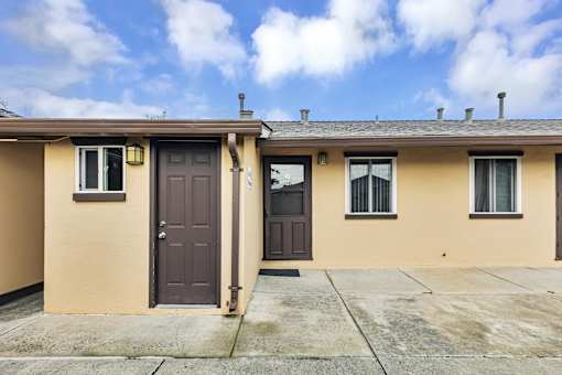 A house with a brown door and windows.