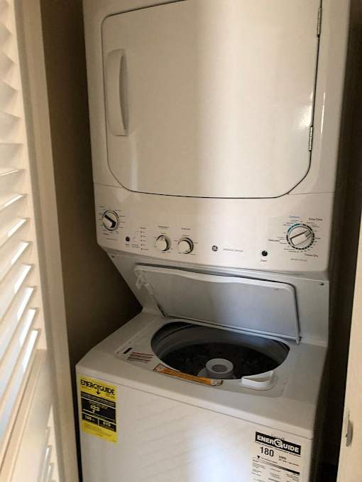 A white EnerGuide 180 washing machine is in a small space.