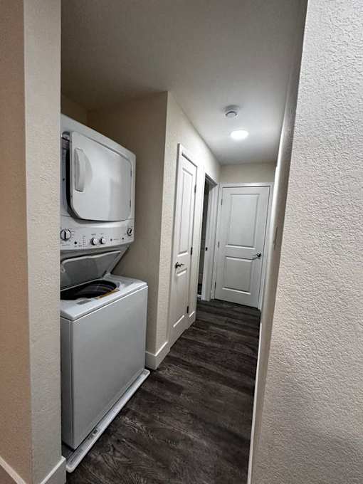 a hallway with a washing machine and a television