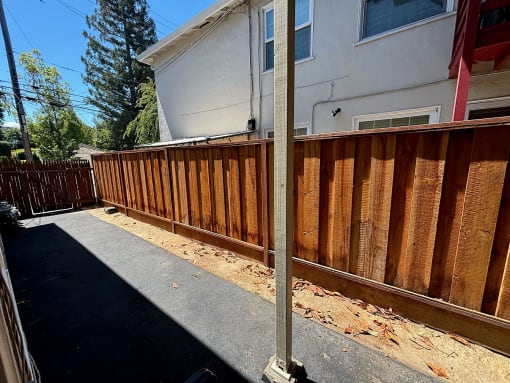 a wooden fence in front of a house