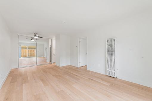 A room with wooden floors and white walls.
