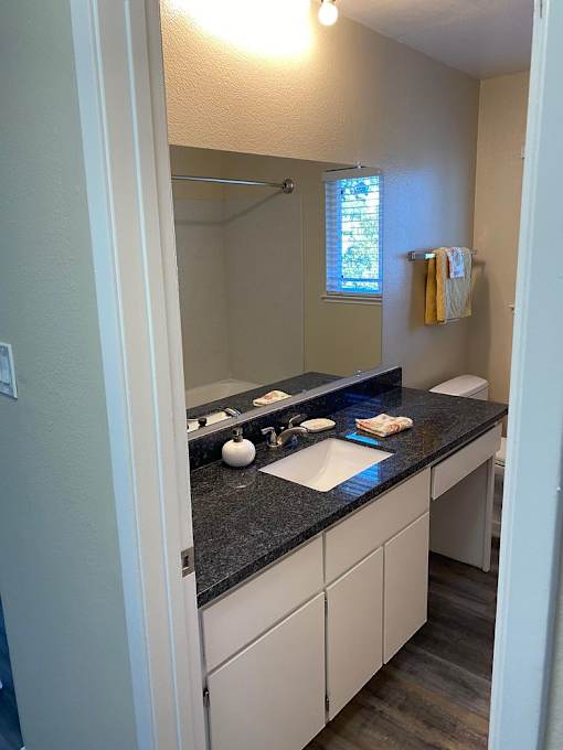 A bathroom with a sink and mirror.