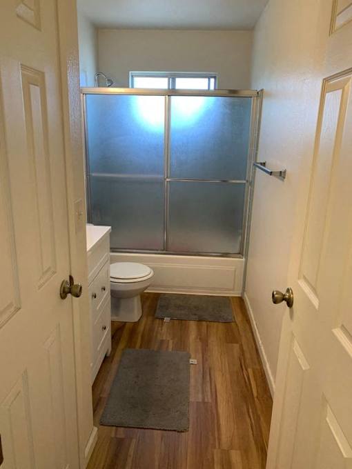 a bathroom with a toilet and a shower