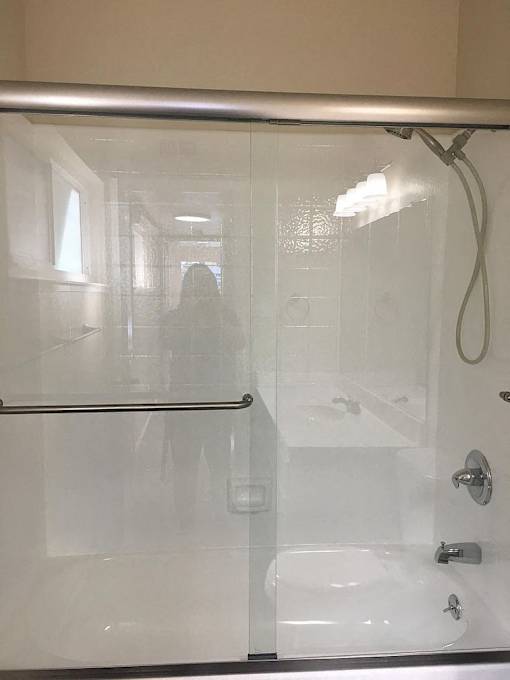 a bathroom with a shower with a glass door