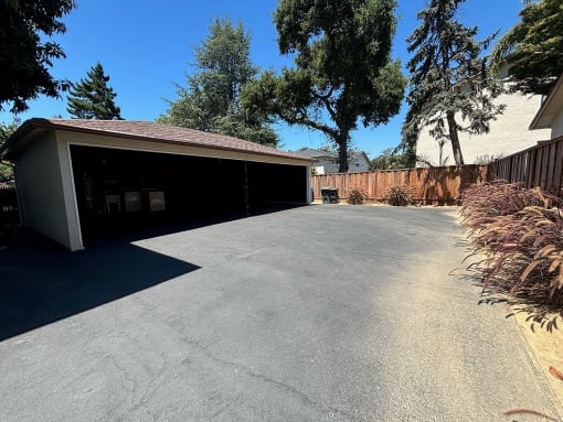a car garage with a driveway in front of a house
