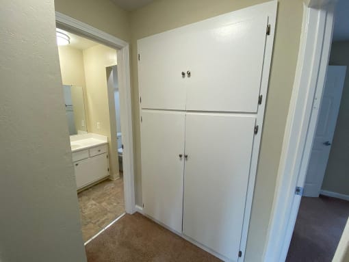 a kitchen with white cabinets and a white refrigerator