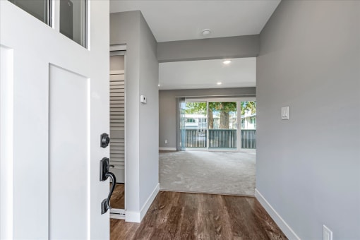 a renovated living room with a door to a balcony