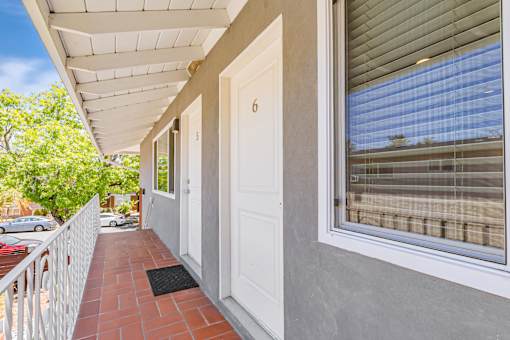 A white door is on the right side of a house.