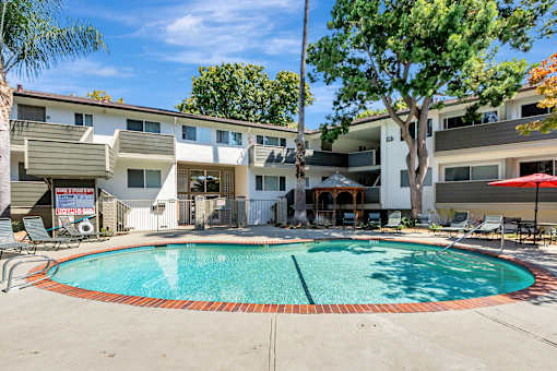 A swimming pool surrounded by apartment buildings.