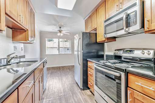 A kitchen with wooden cabinets and stainless steel appliances.