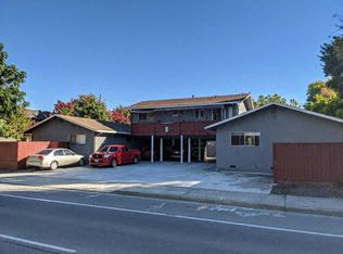 a house with a red car parked in a parking lot