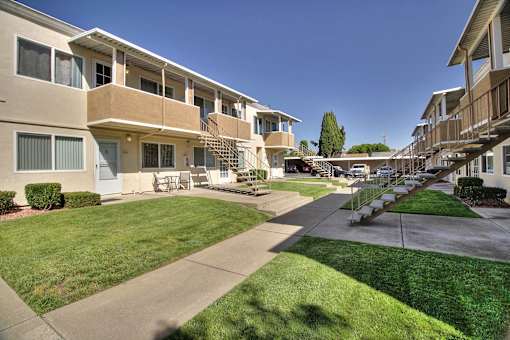 Apartment complex with a green lawn in front.