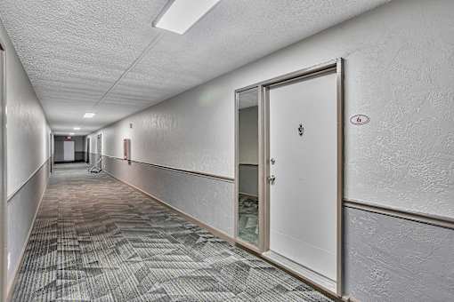 A long hallway with a door on the right.