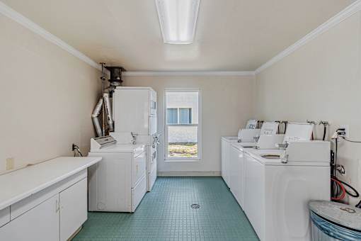 A laundry room with a washer and dryer in it.