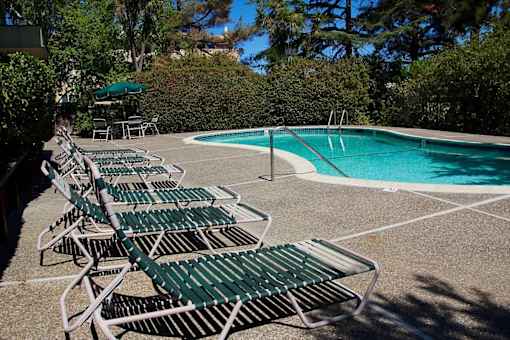 A pool with chairs around it.