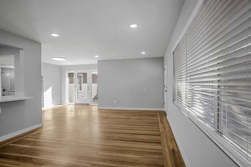 A room with wooden floors and white walls.