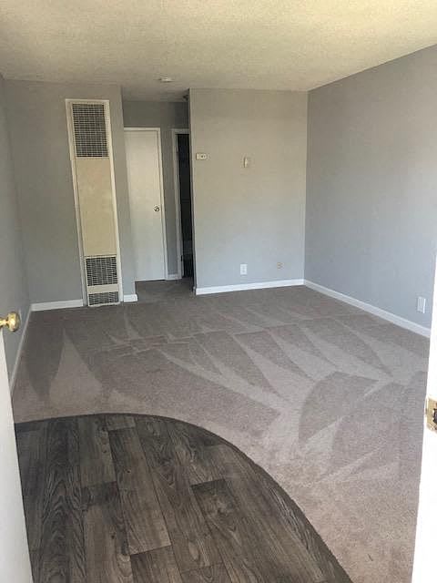 A room with a wooden floor and a white door.