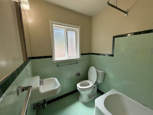 a bathroom with a toilet and a sink and a tub