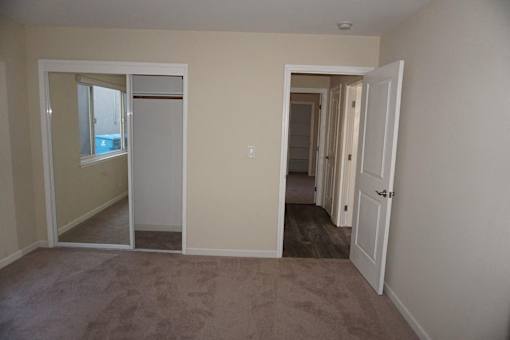 A room with a carpeted floor and white walls.