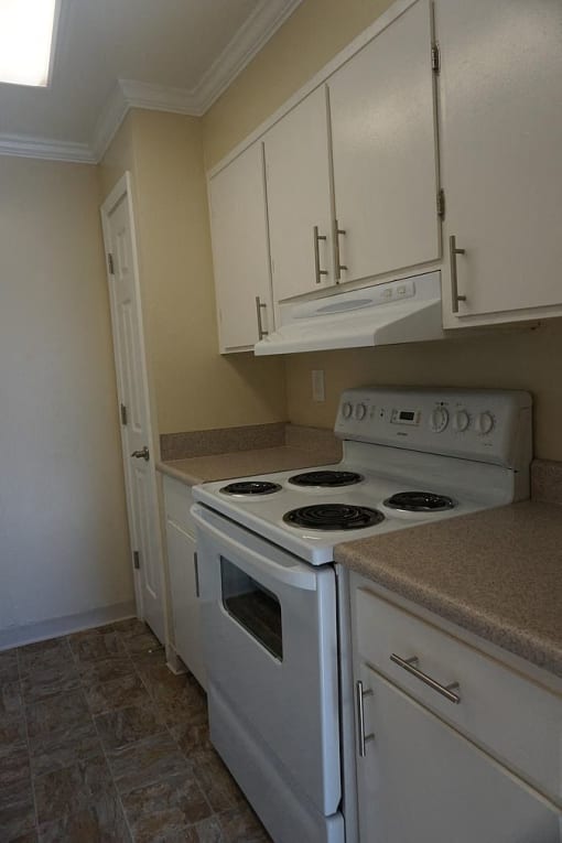 a kitchen with white appliances and white cabinets