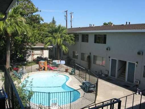 a large swimming pool in front of a house