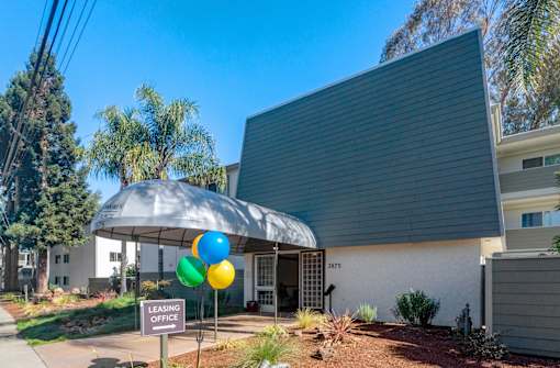 a building with an umbrella and balloons in front of it