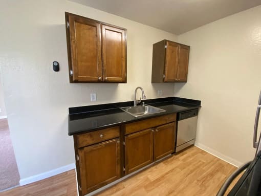 a kitchen with a sink and wooden cabinets
