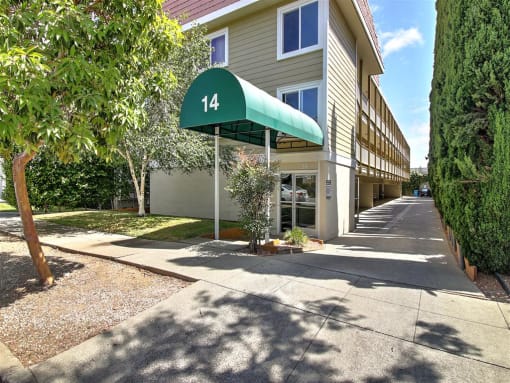 a building with a green canopy in front of it