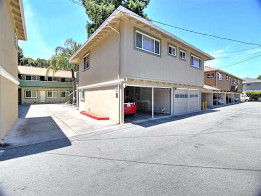A red car is parked in a garage.