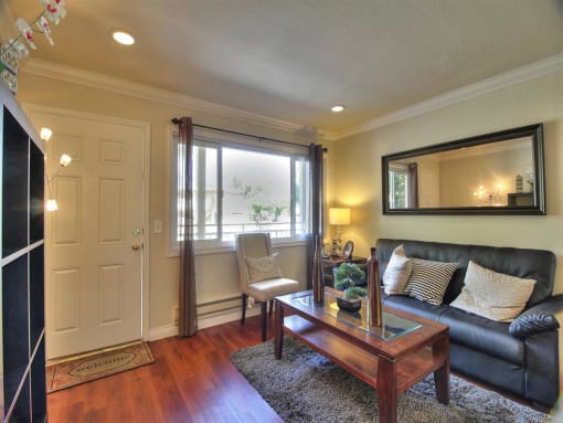 airy living room with coach and coffee table at The Arbors at Mountain View, California, 94040