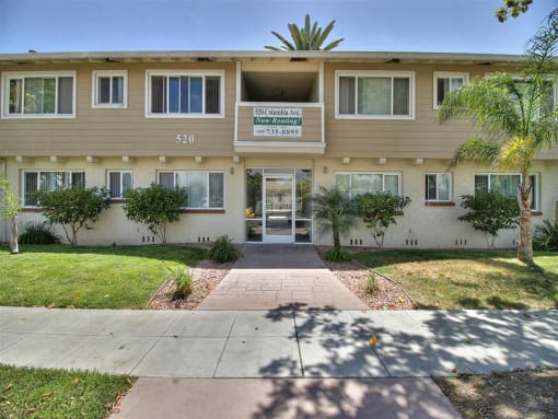 The image shows the front of a building with the number 520 and a sign that reads