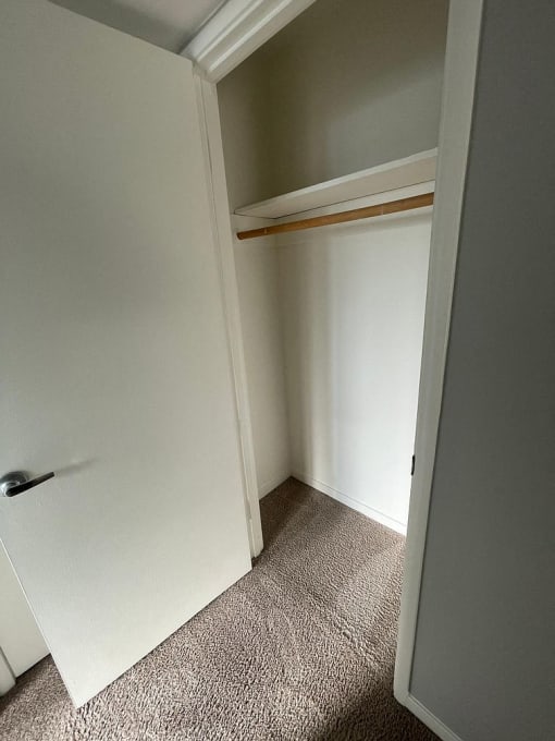 a small room with a closet and a door