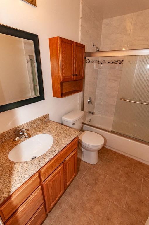 a bathroom with a sink toilet and a shower