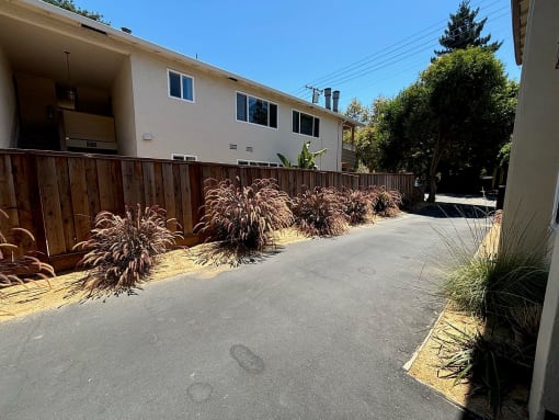 an empty driveway in front of a house