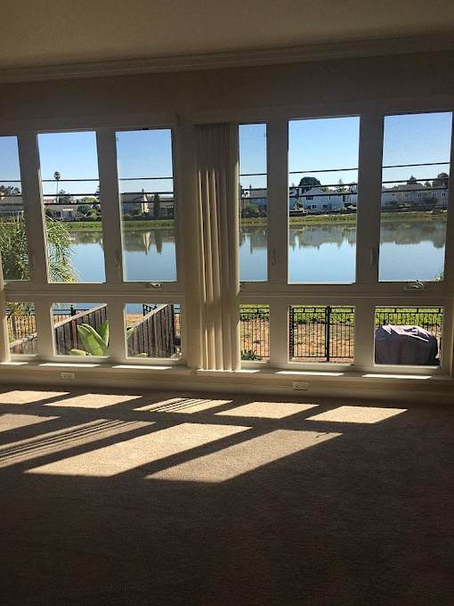 a living room with windows overlooking a body of water