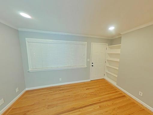 A room with wooden floors and a white door.