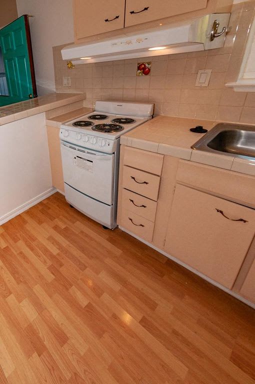 a small kitchen with a stove and a sink