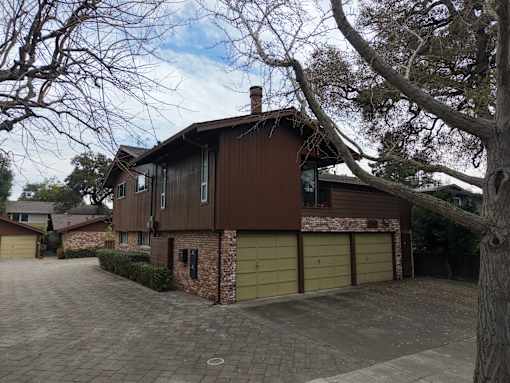 A house with a brown roof and a garage door.