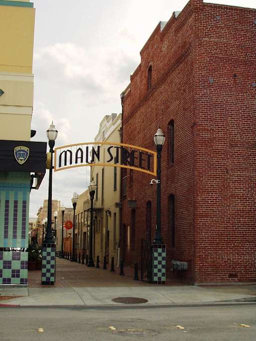 a street with a brick building and a sign for main street