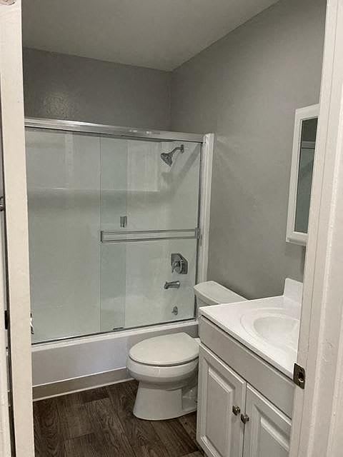 A white toilet sits next to a sink in a small bathroom.