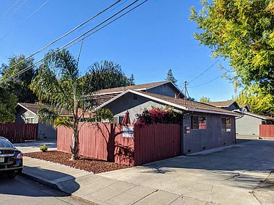 a house with a red fence and a driveway