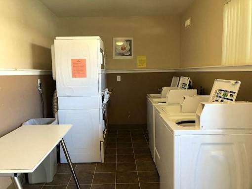 a kitchen with white appliances and a white refrigerator