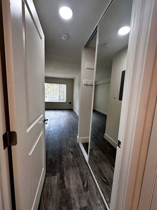 a empty room with a mirror and a door